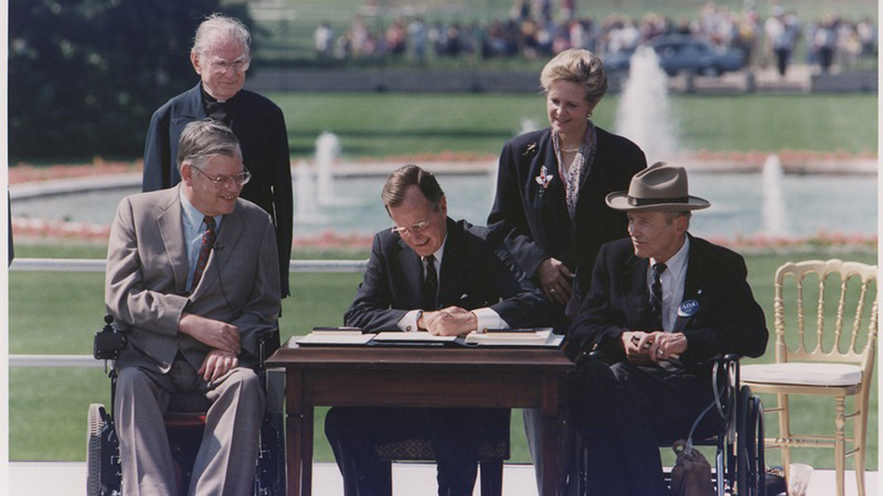 President Bush signing into law the Americans with Disabilities Act of 1990 on the South Lawn of the White House