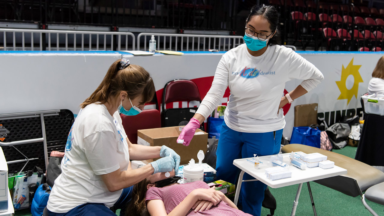 A child receives a free dental screening at an event sponsored by Arizona PBS and Delta Dental