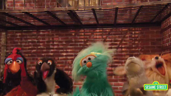 Sesame Street characters sing a song in Spanish