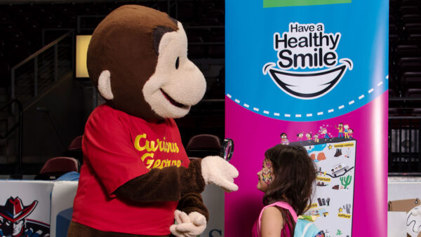 Curious George helps kids learn about healthy teeth and gums at a Delta Dental of Arizona event