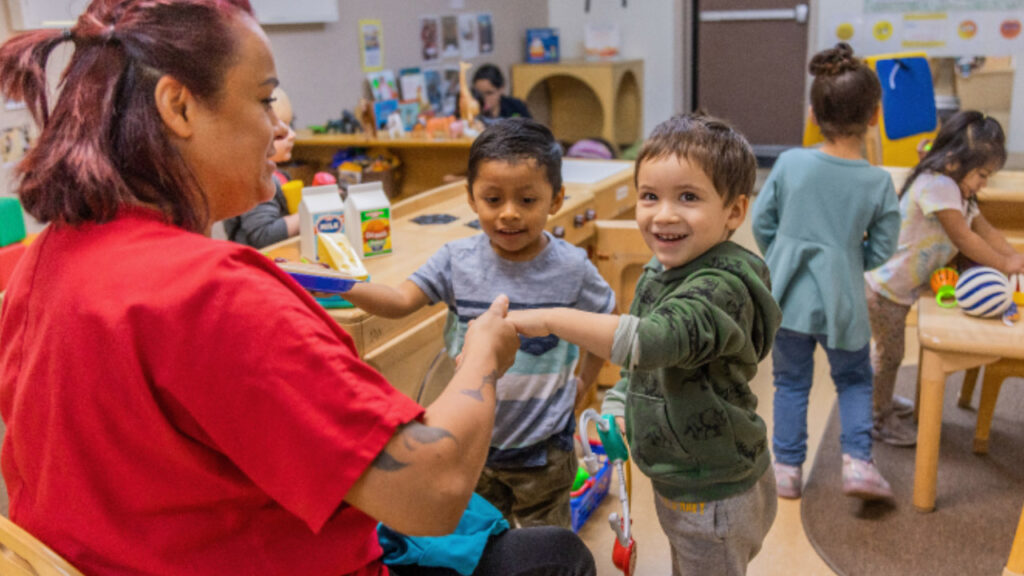A teacher in the classroom with young students