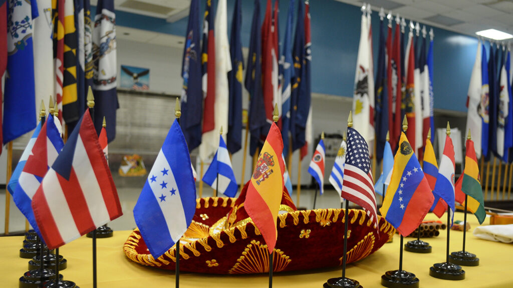 flags of Spanish speaking countries and a sombrero on a table