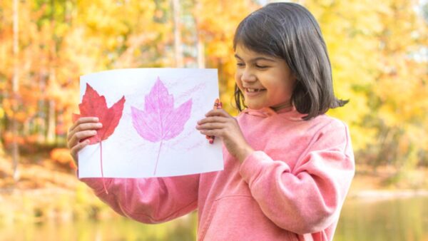 A young girl works on a craft to Celebrate Fall