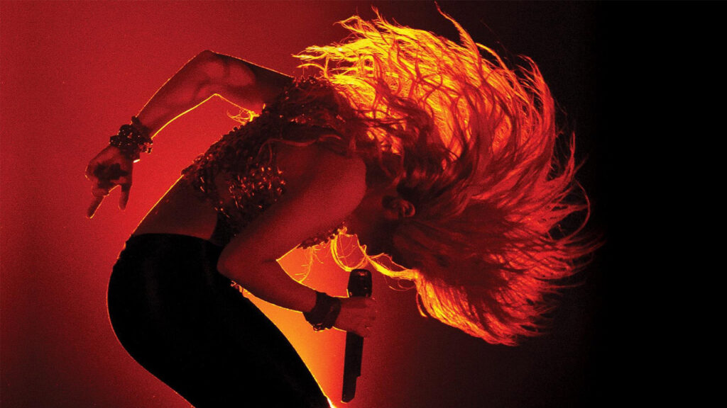 Shakira flinging her hair and performing live on stage in Paris