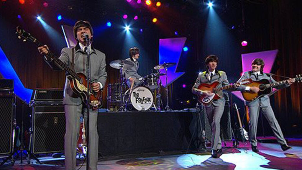 Beatles' cover band, The Fab Four, perform live on stage