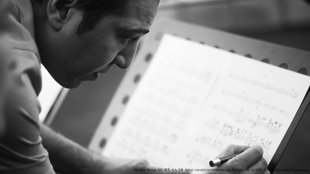 composer Fazil Say writing on a musical score