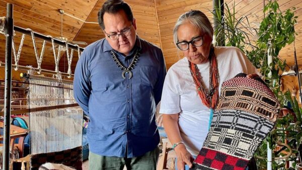 Two Native Americans share their stories by showing how weaving captures their history