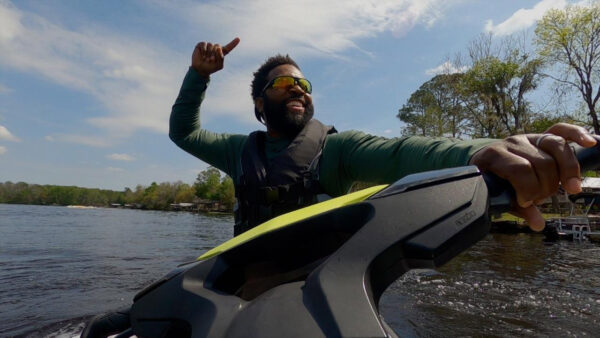 Baratunde Thurston on a jet ski with a big smile on his face
