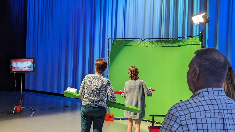 Students take part in a green screen live video activity at the 2023 Digital Video Contest awards celebration