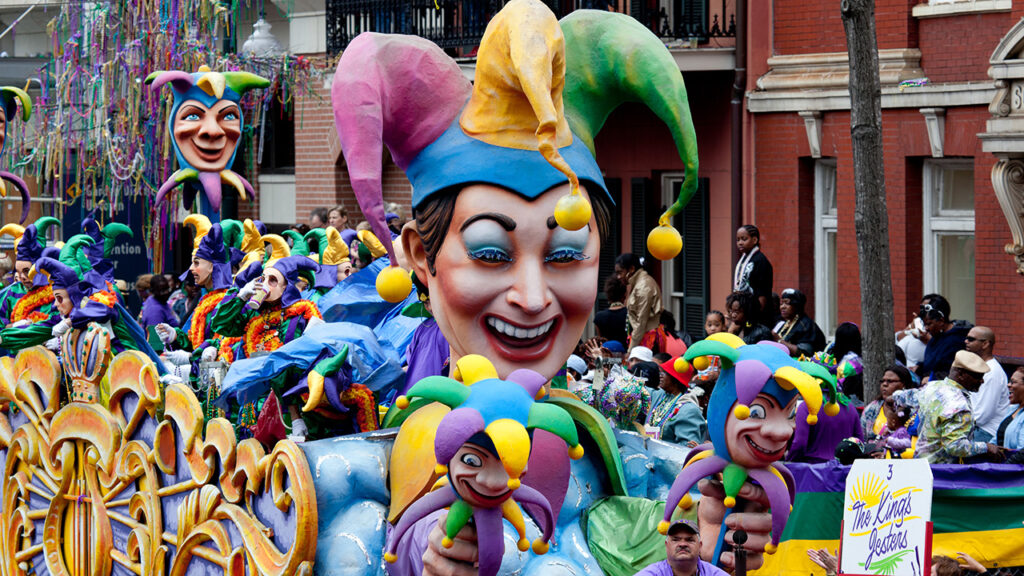 mardi gras parade with large jester head