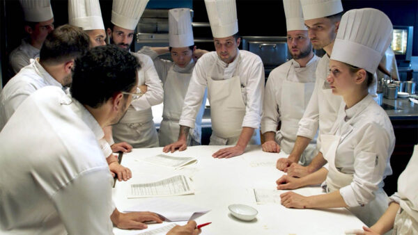 Chefs gathered around a table for Menus-Plaisirs – Les Troisgros