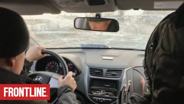 Reporters drive through the city of Mariupol, Ukraine