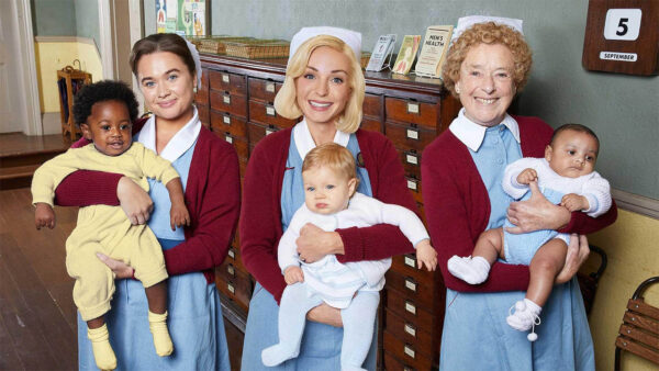 Main characters from Call the Midwife holding babies for season 13