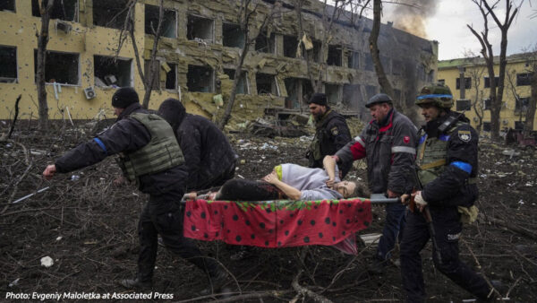 Rescuers help a pregnant woman in Mariupol; photo by Evgeniy Maloletka at Associated Press