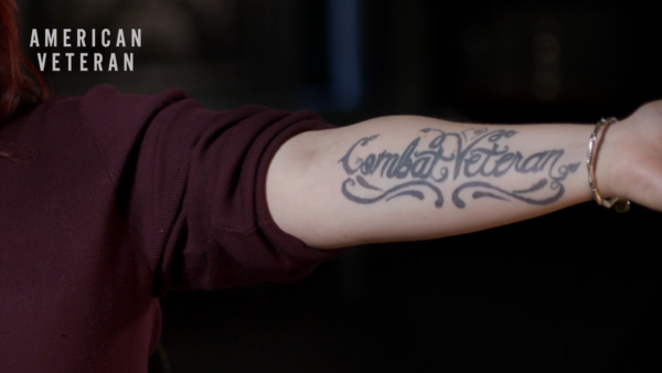 A woman showing her military tattoo