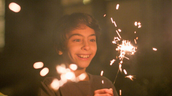 A boy playing with a sparkler for an episode of 