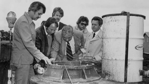 A group of men looking at the chemical at the Love Canal