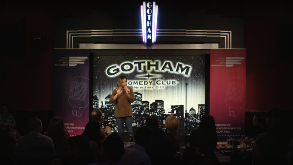 A woman doing stand up comedy