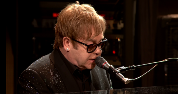 Elton John singing at his concert