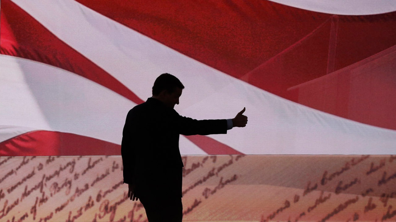 Silhouette of a politician gives a thumbs up with an American flag in the background
