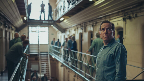 Professor T looking around a prison
