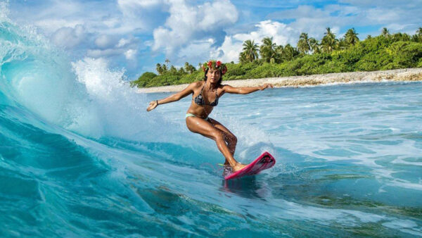 Surfer Vahine Fierro catches a wave