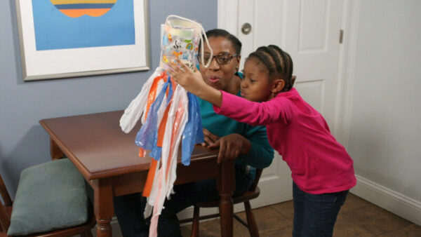 A mother and daughter make a windsock