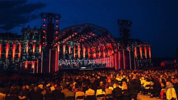 Listeners sit in the audience, enjoying the Vienna Philharmonic Summer Night Concert.