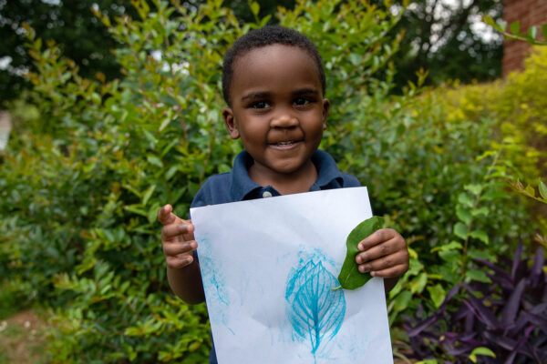 A boy with his leaf and bark rubbing paper