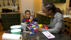 A boy and his mom make an ice sculpture