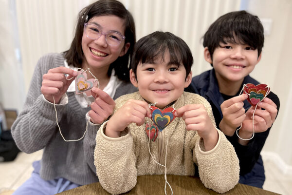 Three kids with their heart necklaces