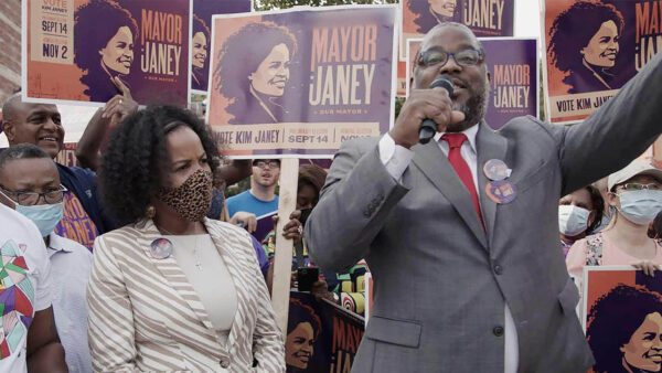 Kim Janey with a speaker at a rally