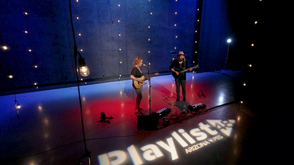 A band made up of a man and woman on guitar plays in the studio at Arizona PBS