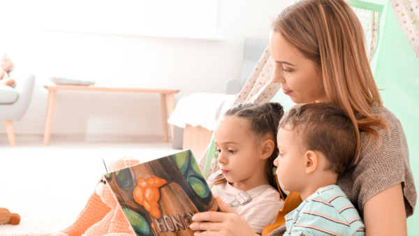 A mom and kids read a book