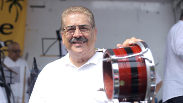 A man holding a small drum