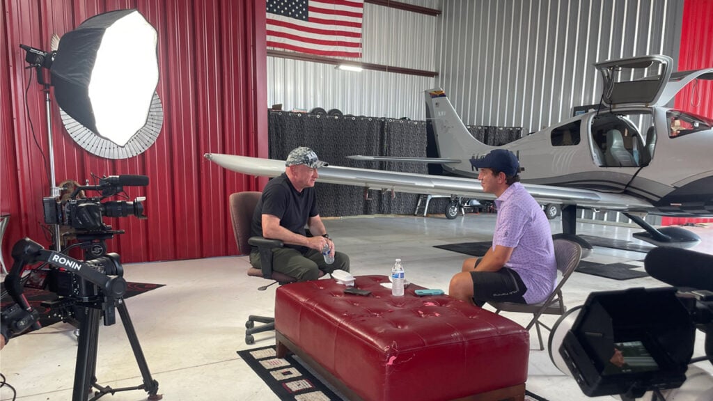 Mark Kelly sits down for an interview in an airplane hangar
