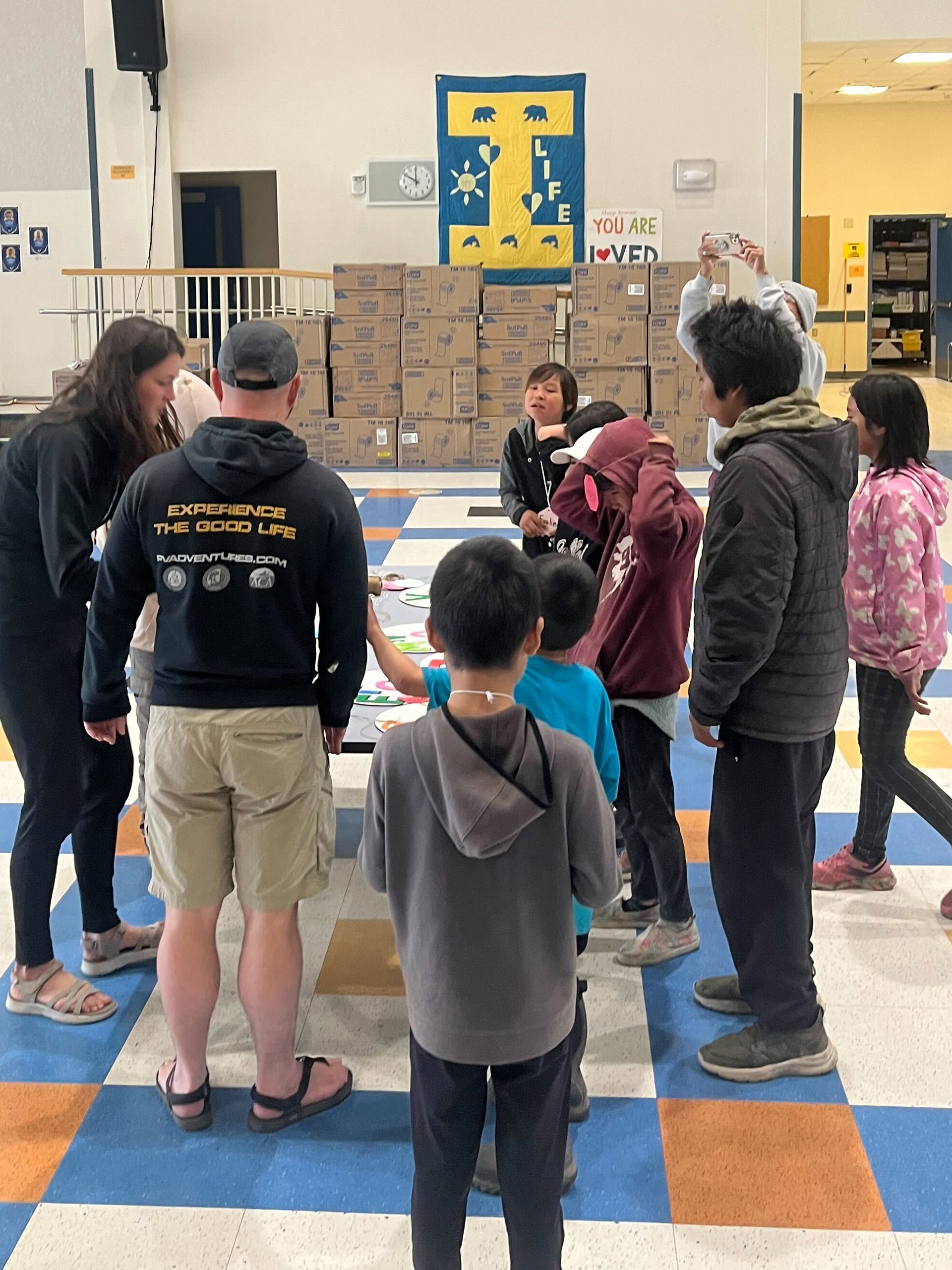 A diverse group of children encircling a table actively involved in a collaborative and enjoyable task.