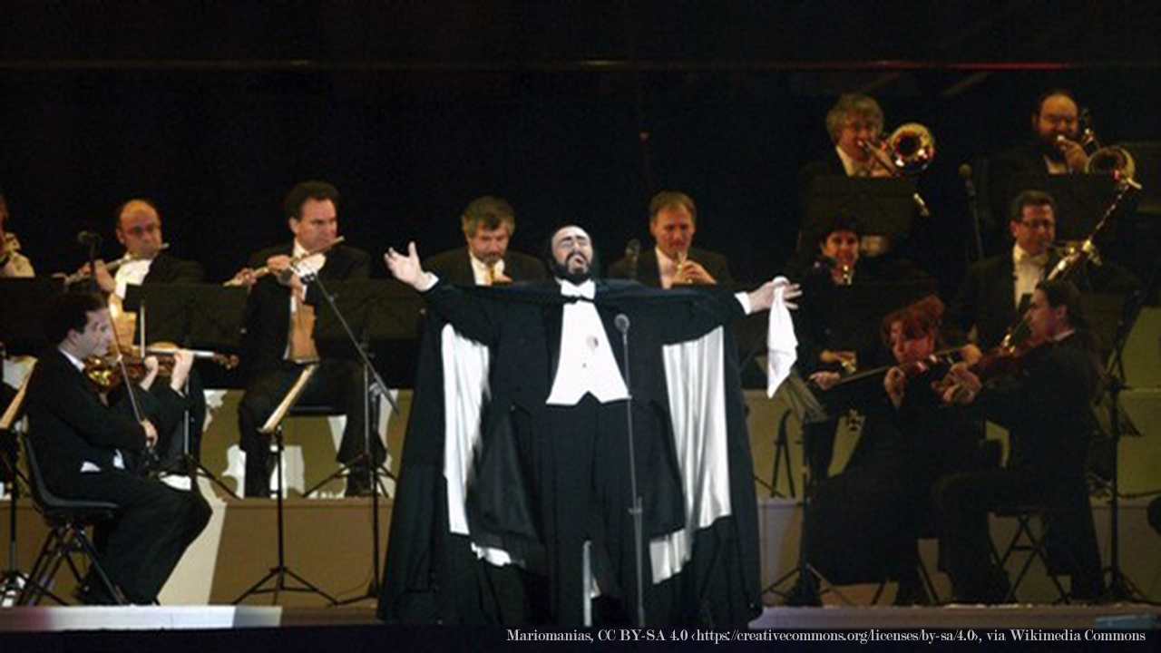 Luciano Pavarotti singing on stage