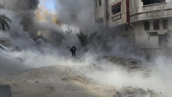 A man runs through the street in the Israeli and Palestinian conflict