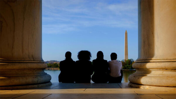 students sitting in front of a view of Washington monument