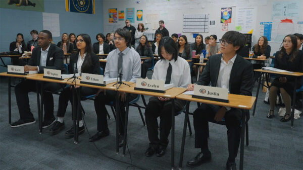 Students sitting in a mock Congressional meeting