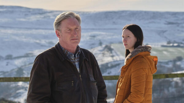 Alex Ridley and a woman standing in the snow