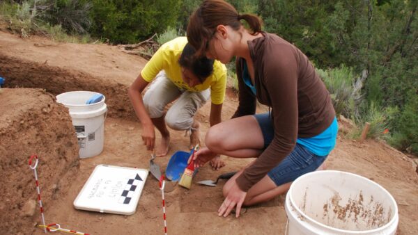 Two women digging for fossils