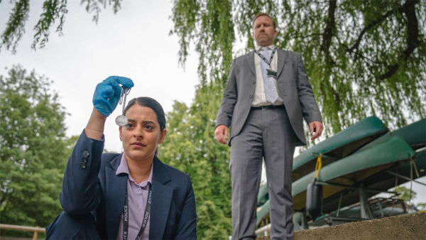 Two police officers looking at evidence