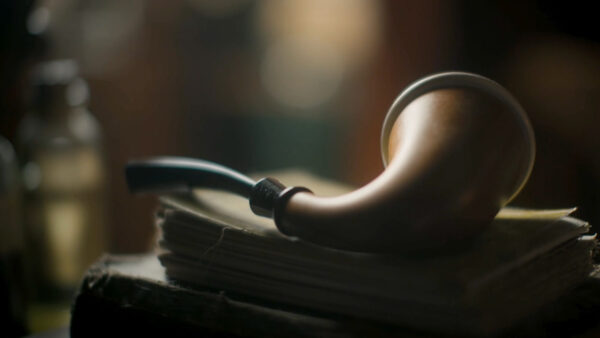 A cigar on a stack of books from 