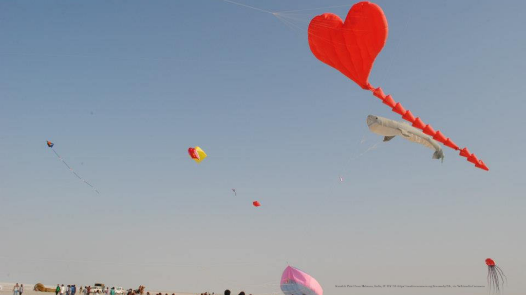 A heart-shaped kite flies in the sky