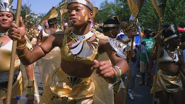 A group of African American women adorned in shimmering gold, traditional attire.