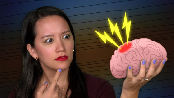 A woman holds a graphic of an injured brain