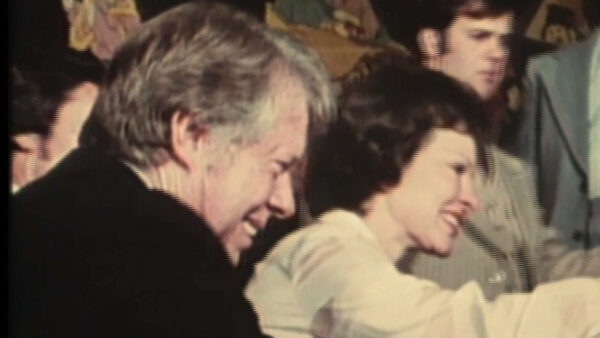 Jimmy Carter shaking hands in a crowd alongside his wife