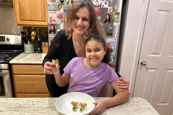 A mom and her daughter make butterfly snacks